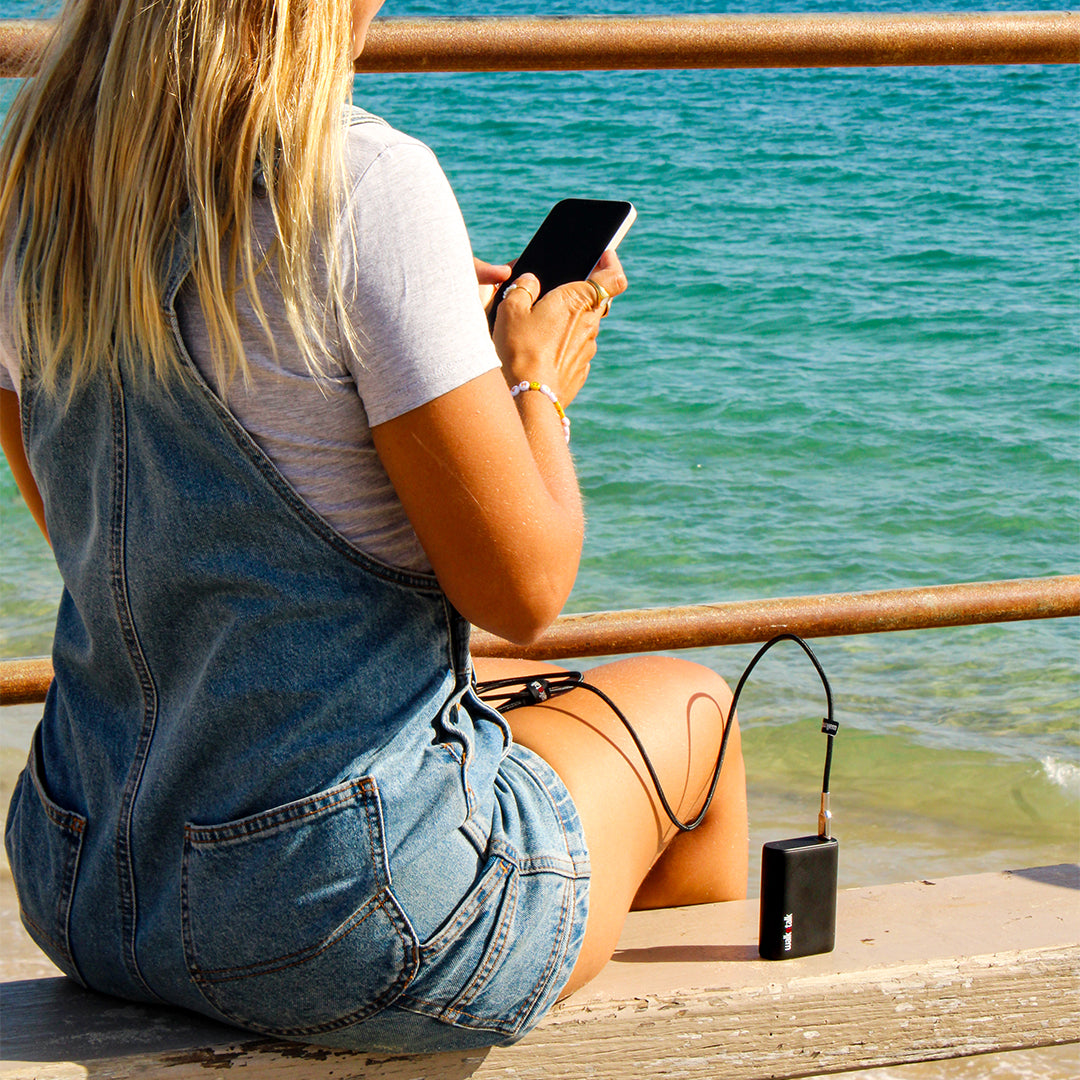 Woman charging her Samsung phone with the Fast Charge Quick Charge Android and Samsung USB-C to USB-C cable